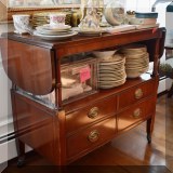 F14. Double drop leaf sideboard on casters with two drawers. 35”h x 59”w x 19”d 